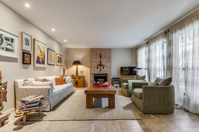 living room with a brick fireplace