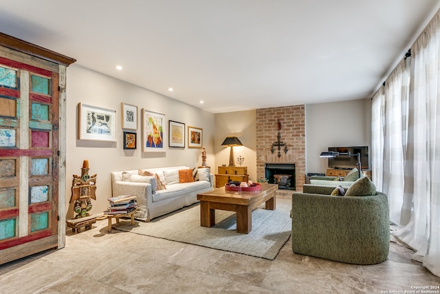 living room featuring a brick fireplace