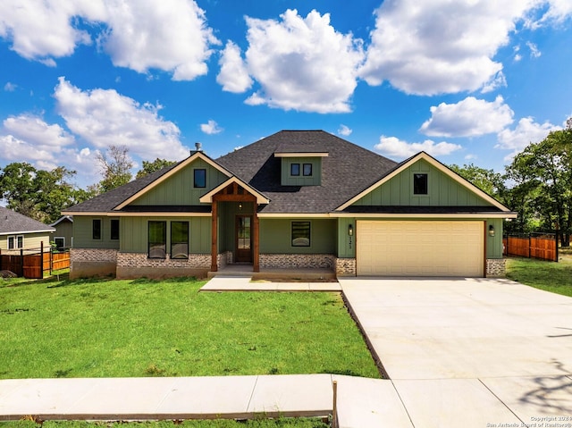 craftsman inspired home with a front yard and a garage