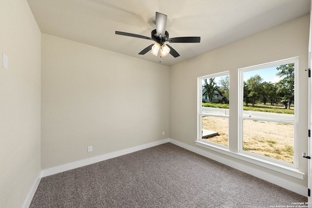 carpeted spare room with ceiling fan