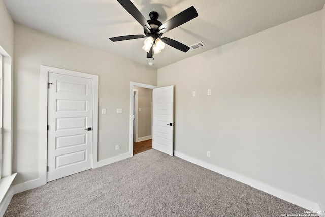 unfurnished bedroom featuring ceiling fan and carpet flooring