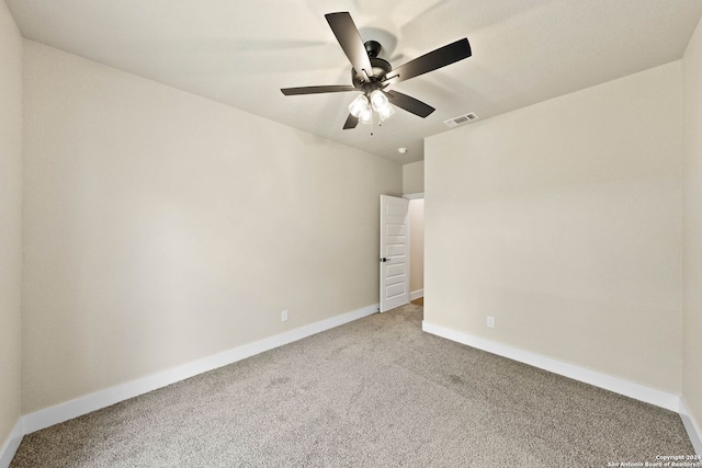 carpeted spare room with ceiling fan