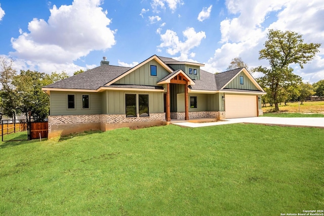 craftsman inspired home featuring a front lawn and a garage