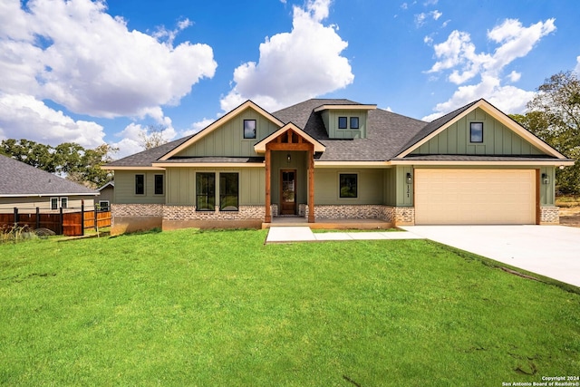 craftsman-style house featuring a front yard and a garage