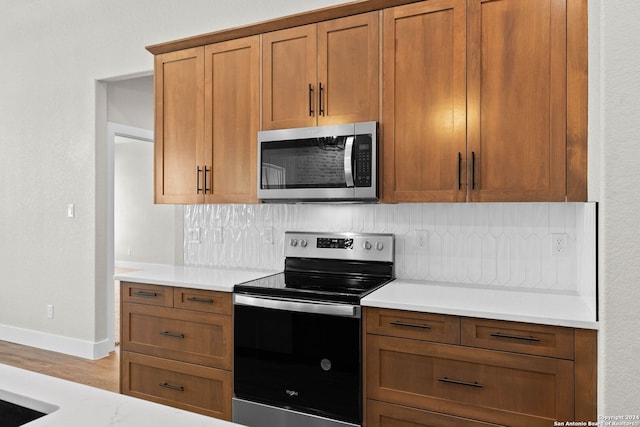 kitchen featuring appliances with stainless steel finishes and tasteful backsplash