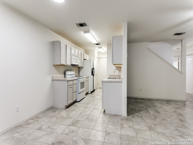 kitchen with white appliances and sink