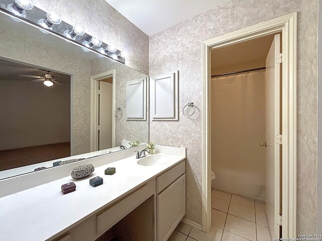 bathroom with ceiling fan, vanity, toilet, a shower with curtain, and tile patterned flooring