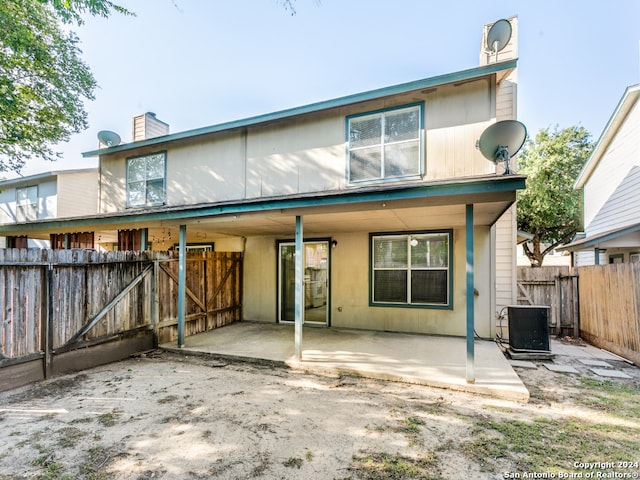 rear view of house with a patio area and central air condition unit