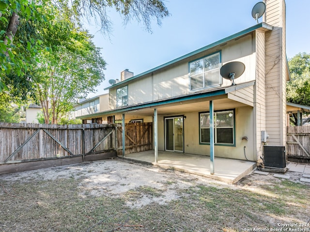 rear view of house featuring cooling unit and a patio