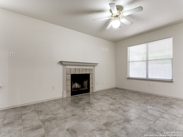 unfurnished living room featuring ceiling fan and a fireplace