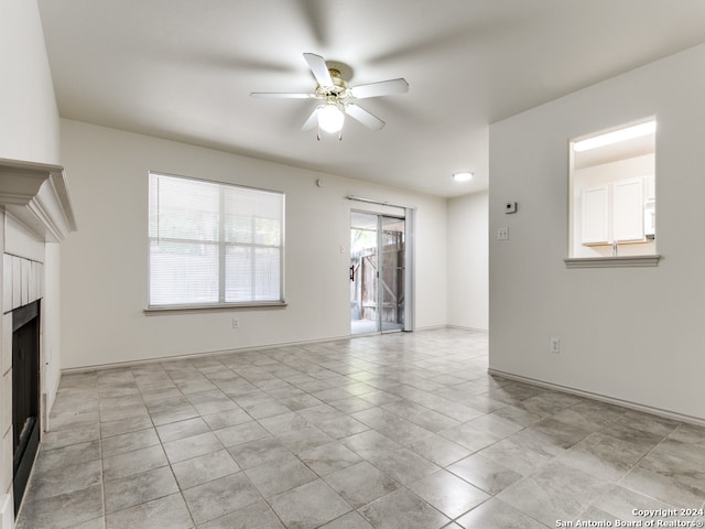 unfurnished living room with ceiling fan and light tile patterned flooring