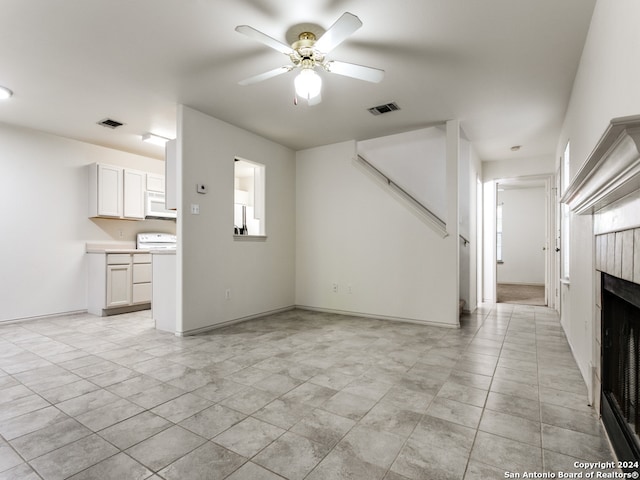 unfurnished living room with ceiling fan