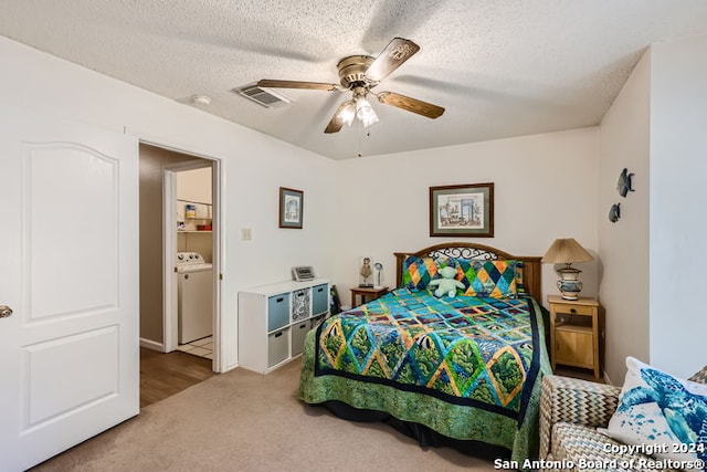 carpeted bedroom featuring ceiling fan, separate washer and dryer, and a textured ceiling