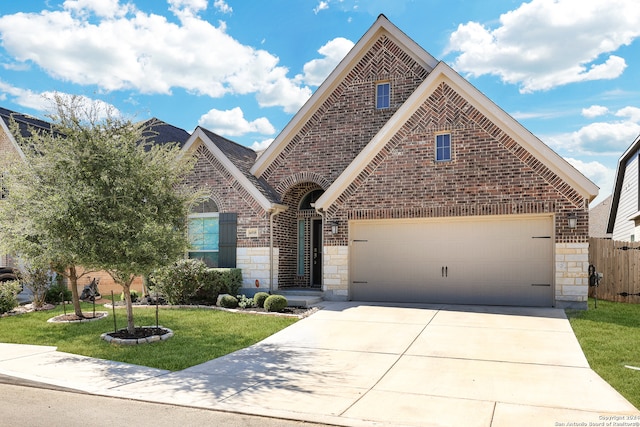 view of front of house featuring a front yard and a garage