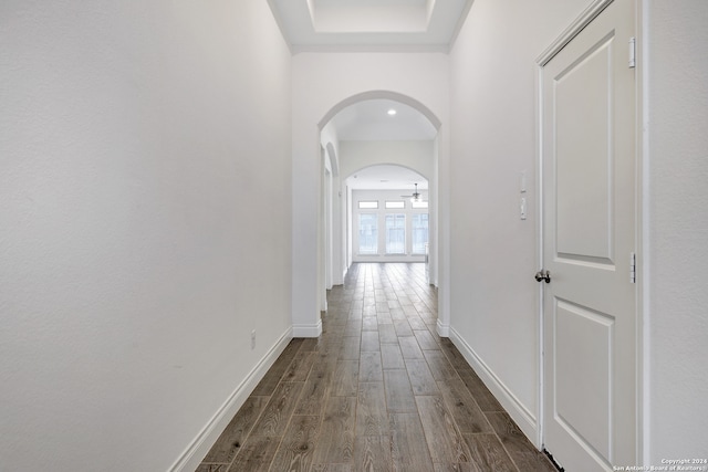 corridor with dark hardwood / wood-style flooring