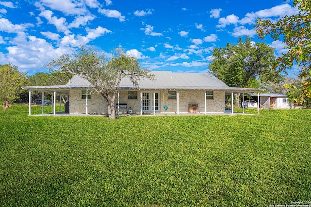 back of property with a lawn