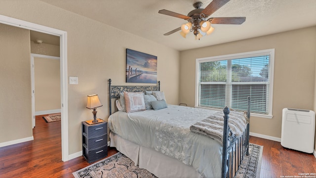 bedroom featuring ceiling fan and dark hardwood / wood-style flooring