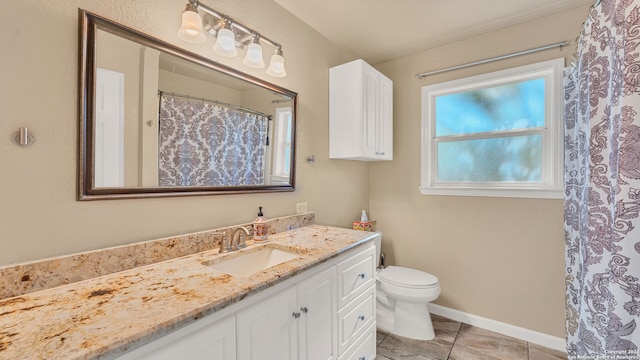 bathroom with vanity, toilet, and tile patterned floors