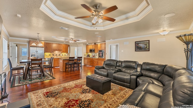 living room with a textured ceiling, crown molding, and dark hardwood / wood-style floors