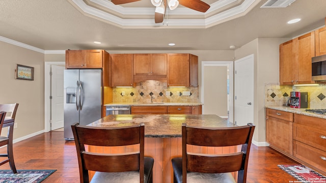 kitchen featuring dark hardwood / wood-style floors, sink, backsplash, appliances with stainless steel finishes, and crown molding