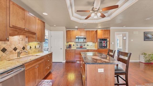 kitchen featuring a kitchen breakfast bar, stainless steel appliances, a kitchen island, and dark hardwood / wood-style flooring