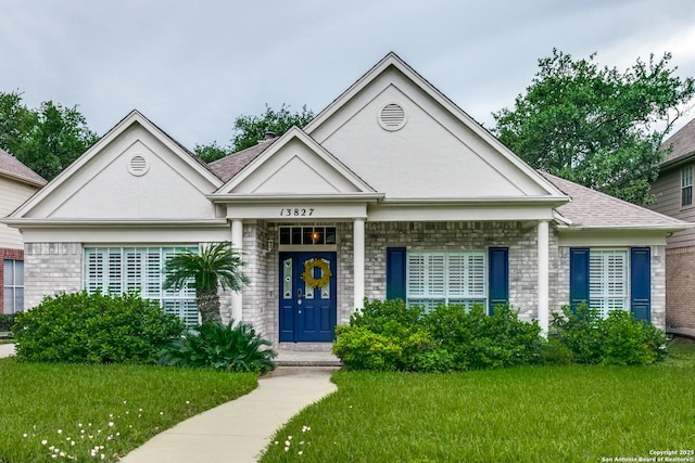 view of front of home featuring a front yard and brick siding