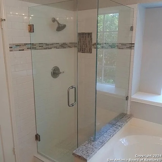 bathroom with a shower with shower door