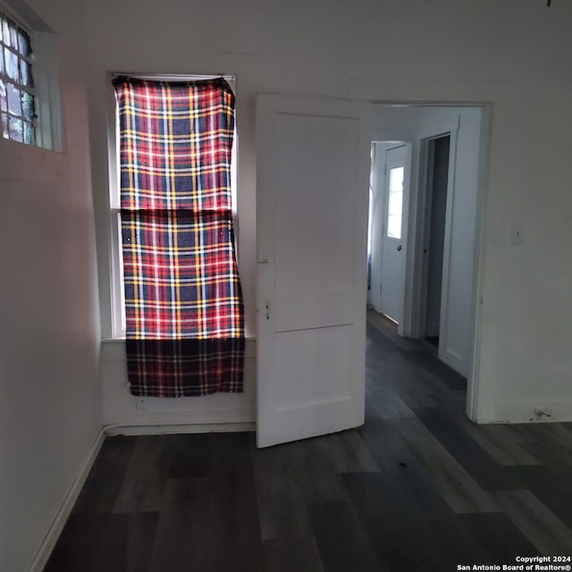 spare room featuring dark hardwood / wood-style floors and plenty of natural light