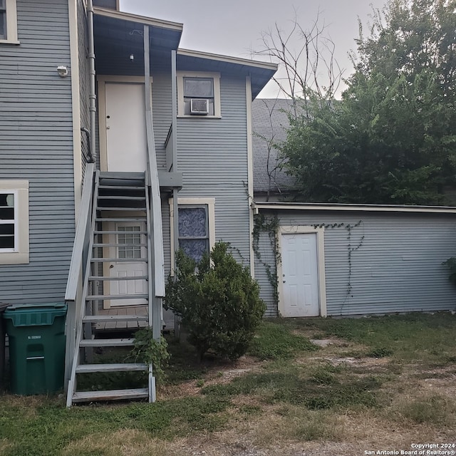 rear view of house with cooling unit