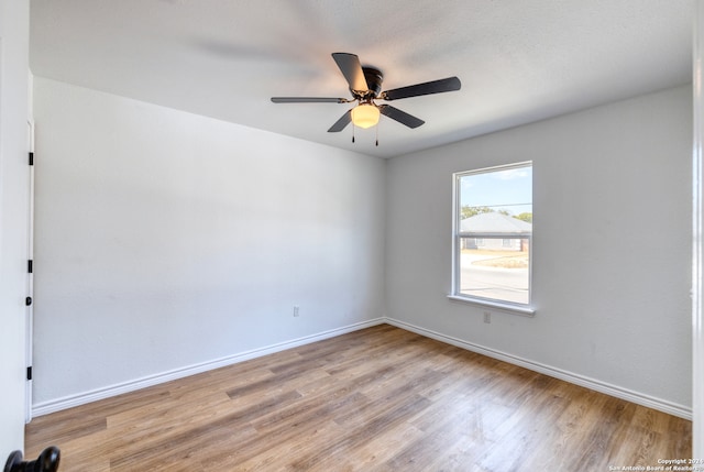 spare room with light hardwood / wood-style flooring and ceiling fan