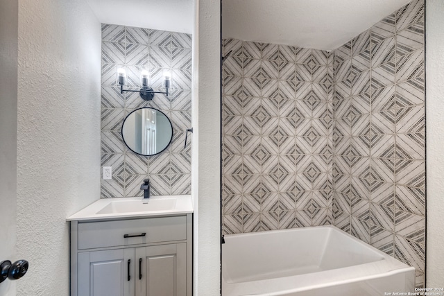 bathroom with vanity and a washtub