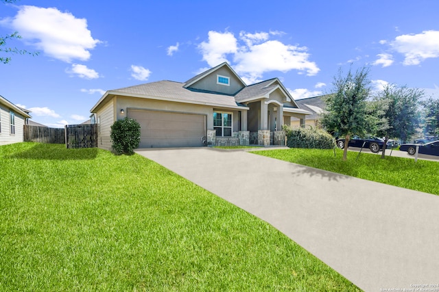 view of front of property with a front yard and a garage