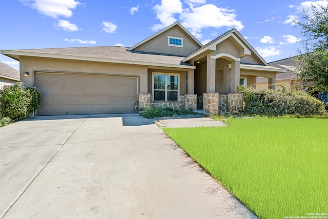 view of front facade with a front lawn and a garage