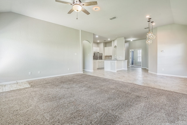 unfurnished living room with lofted ceiling, light hardwood / wood-style floors, and ceiling fan