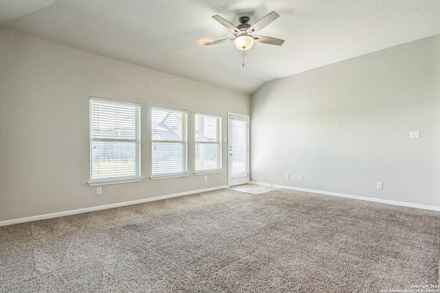 empty room with carpet floors, lofted ceiling, and ceiling fan