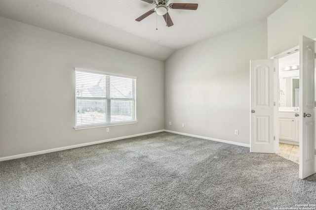 carpeted empty room with lofted ceiling and ceiling fan