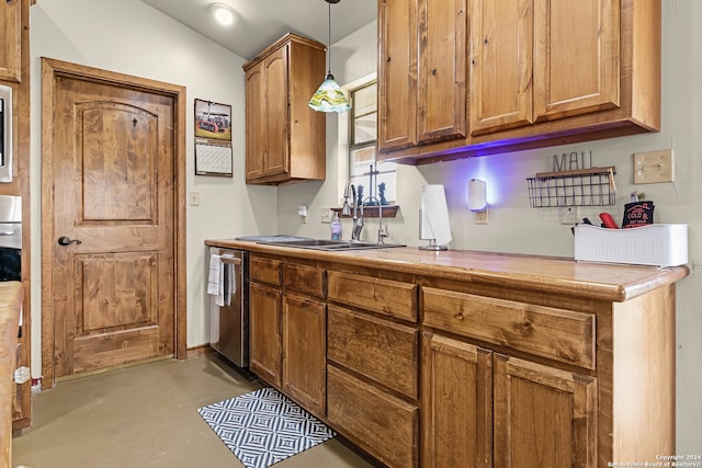 kitchen featuring stainless steel dishwasher, sink, and pendant lighting