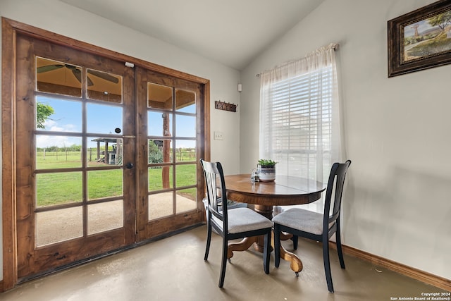 dining room with french doors, vaulted ceiling, a healthy amount of sunlight, and ceiling fan