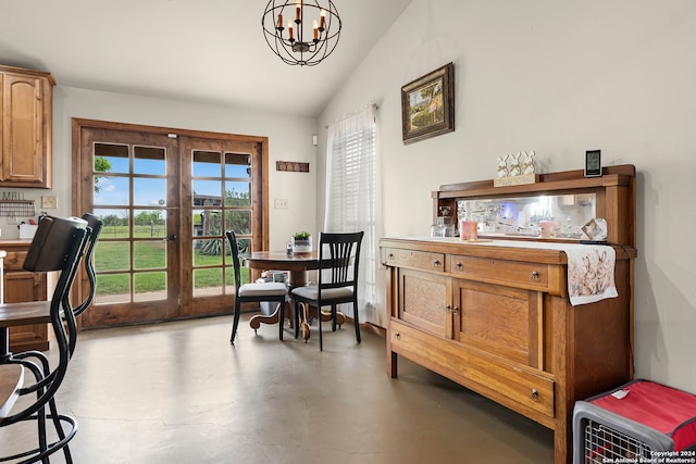 dining space with a chandelier, french doors, a healthy amount of sunlight, and concrete floors