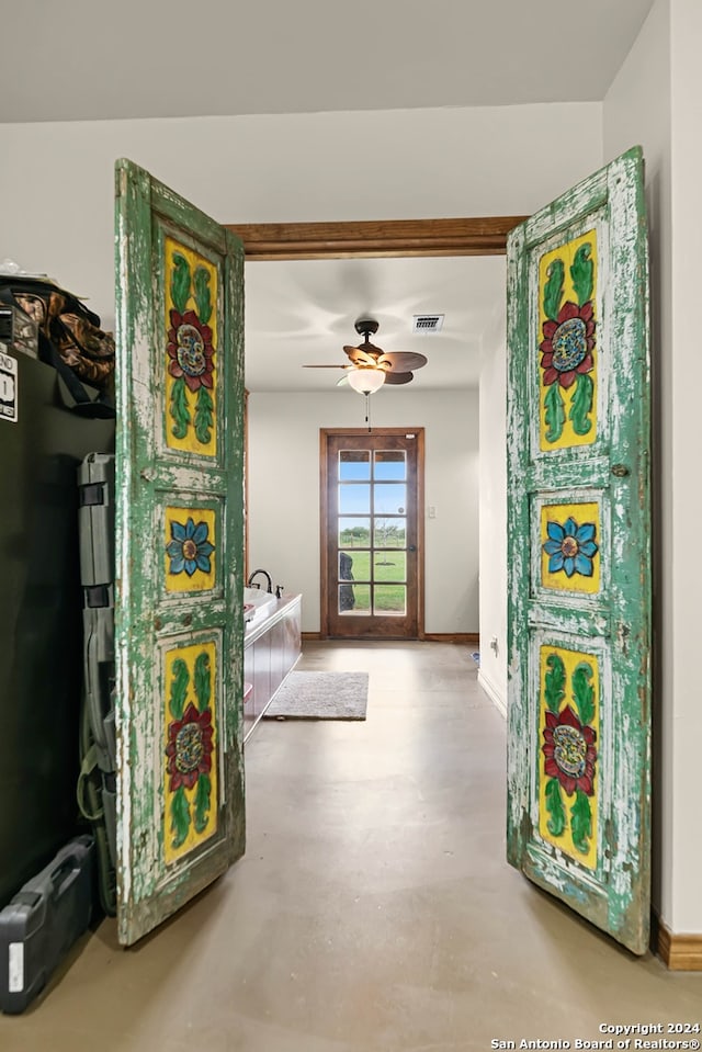 hall featuring concrete flooring