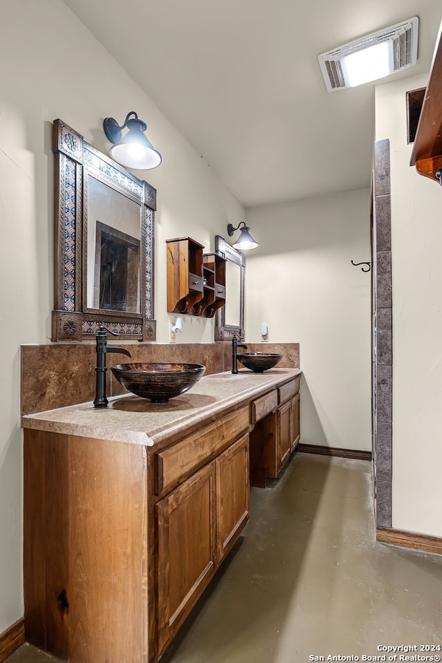 bathroom with vanity and concrete floors