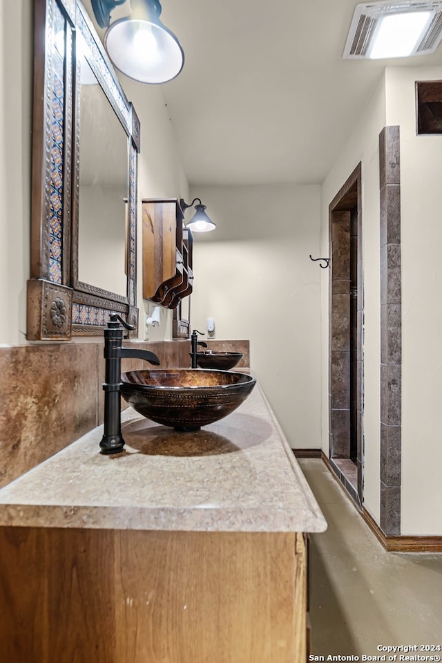 bathroom with vanity and concrete flooring