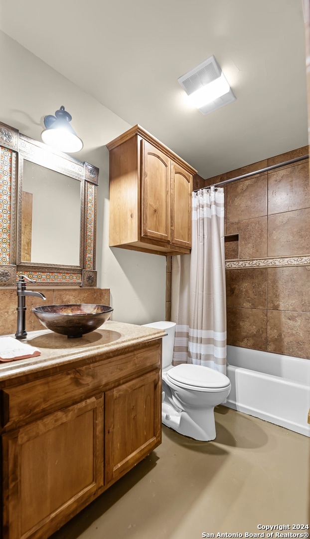 full bathroom featuring vanity, concrete flooring, toilet, and shower / bathtub combination with curtain