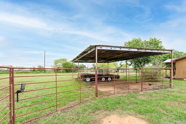 view of yard featuring a rural view and an outdoor structure