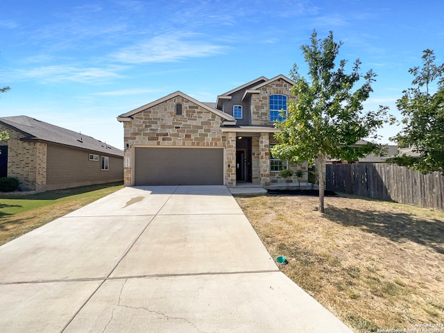 view of front of property featuring a garage and a front lawn