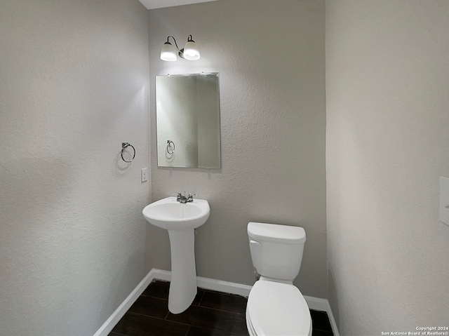 bathroom featuring sink, tile patterned floors, and toilet