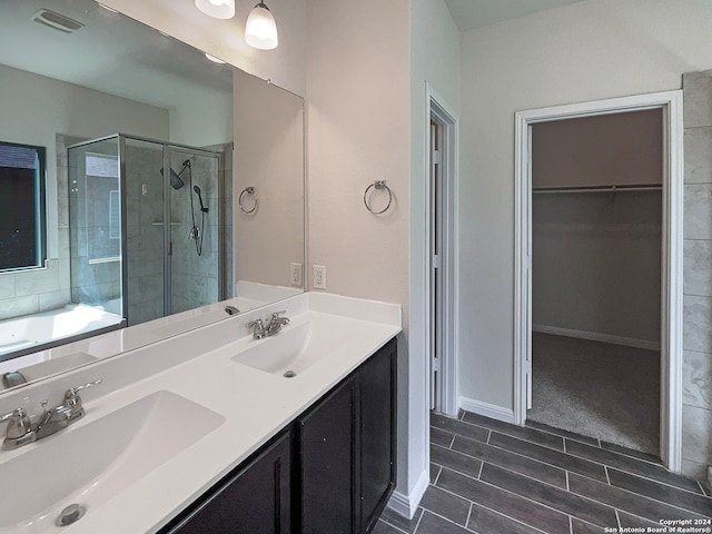 bathroom featuring plus walk in shower and vanity