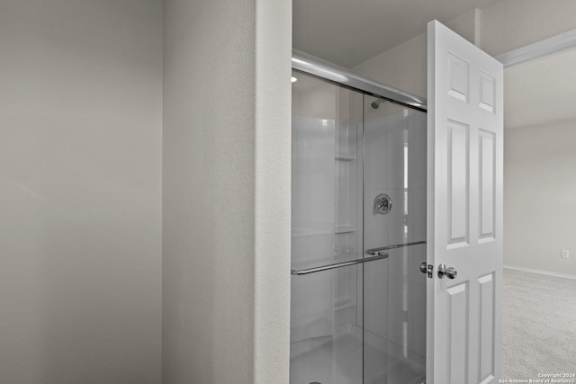 full bath with baseboards and a stall shower