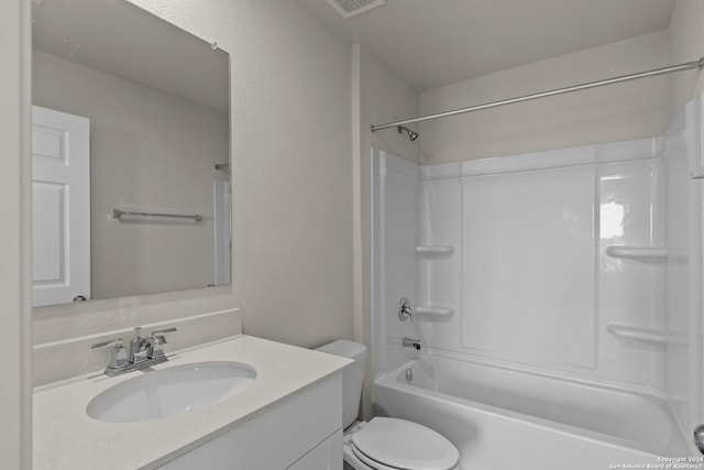 full bathroom featuring washtub / shower combination, a textured wall, toilet, and vanity