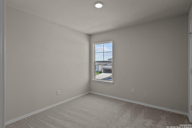 unfurnished room featuring carpet floors and baseboards